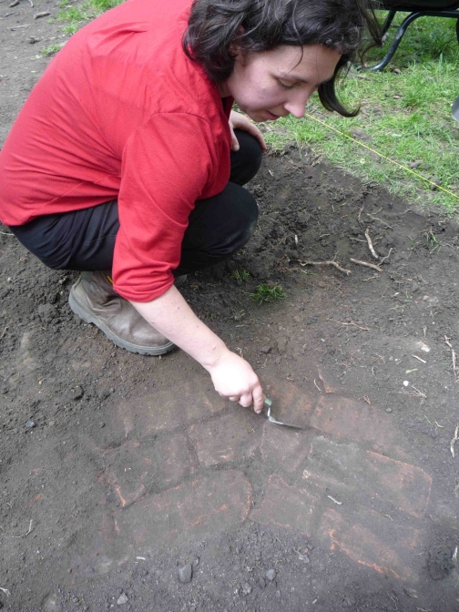 Hannah uncovering the foundations of the bandstand 4th July 2012 (Photograph: S. Jones)